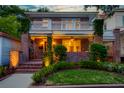 An exterior view of a brick two-story home featuring a white balcony with greenery at 340 President St, Charleston, SC 29403