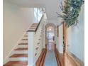 Welcoming foyer with hardwood floors, stairs, a blue runner, and decorative wreath at 340 President St, Charleston, SC 29403