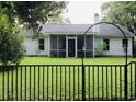 Backyard view showcasing a screened-in porch and a fenced yard at 3415 Pawtucket St, Charleston, SC 29414