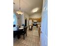 Eat-in kitchen with tiled floors, wooden cabinets and bright light fixture above the table at 3415 Pawtucket St, Charleston, SC 29414