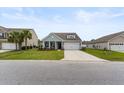 Beautiful gray home with a well-kept lawn, showcasing the two-car garage and welcoming facade at 3431 Great Egret Dr, Johns Island, SC 29455