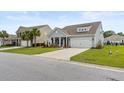 Inviting gray home with well-manicured lawn, two-car garage, and a traditional design at 3431 Great Egret Dr, Johns Island, SC 29455