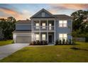 Beautiful two-story home with inviting front porch, visible at dusk at 4007 Oxeye, Johns Island, SC 29455