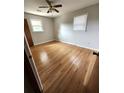 This bedroom features hardwood floors, neutral walls, ceiling fan and natural light at 4029 Karen Dr, North Charleston, SC 29405