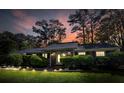 Charming single-story home with a well-maintained front yard at sunset at 411 Dogwood Circle, Summerville, SC 29485