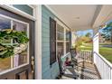 Cozy front porch features rocking chairs, a decorative wreath, and offers an inviting outdoor space at 414 Hamlet Cir, Goose Creek, SC 29445