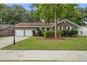 Lovely home with a large driveway, attached garage, and mature trees at 436 Fox Hunt Rd, Goose Creek, SC 29445