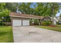 Spacious property with a two-car garage and a long driveway surrounded by lush trees at 436 Fox Hunt Rd, Goose Creek, SC 29445