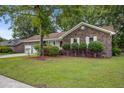 Beautiful brick home with attached garage and green lawn at 436 Fox Hunt Rd, Goose Creek, SC 29445
