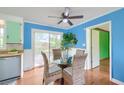 Cozy dining area boasts a glass table, wicker chairs, and sliding door access to the outdoors, blending indoor-outdoor living at 444 Clarine Dr, Goose Creek, SC 29445