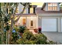 Lovely home showcasing a well-manicured garden and a two-car garage at 448 Jardinere Walk, Mount Pleasant, SC 29464