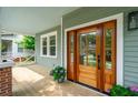 Inviting front door with glass panels, leading to a covered porch and the home's entrance at 4620 O'Hear Ave, North Charleston, SC 29405