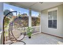 Comfortable front porch showcasing a hanging chair, small plants and plenty of space for relaxation at 469 Hainsworth Dr, Charleston, SC 29414