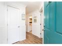 Bright hallway featuring white wainscoting, wood floors, and a glimpse into the bathroom at 509 Summerhouse, Isle of Palms, SC 29451