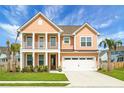Charming two-story home with a welcoming front porch, manicured lawn, and two-car garage at 661 Black Pine Rd, Moncks Corner, SC 29461