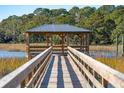 Picturesque wooden dock and gazebo extending into the serene marshland, offering waterfront access at 810 Curved Creek Ct, James Island, SC 29412