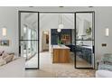 Open concept kitchen with a central island, black cabinets, and modern pendant lighting at 926 Pitt St, Mount Pleasant, SC 29464