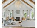 Bright living room with high ceilings, exposed beams, and a cozy fireplace at 926 Pitt St, Mount Pleasant, SC 29464