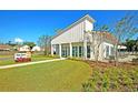 Exterior view of The Club at Mckewn with a manicured lawn and landscaping that provide an inviting community presence at 9712 Transplanter Cir, Ladson, SC 29456