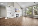 Spacious living room with vaulted ceilings, large windows, fireplace, and built-in shelving offering both style and functionality at 106 Brandy Ct, Summerville, SC 29485