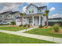 Beautiful two-story home boasts a covered front porch, well-maintained lawn, and inviting curb appeal at 111 Medford St, Summerville, SC 29486