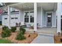 Inviting front porch featuring a cozy swing, seating, and manicured landscaping at 111 Medford St, Summerville, SC 29486