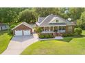 Aerial view of a brick house with a green lawn and a detached two-car garage at 1119 Bruton Blvd, Moncks Corner, SC 29461