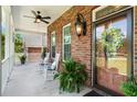 Inviting front porch with brick columns, rocking chairs, and a ceiling fan for relaxing at 1119 Bruton Blvd, Moncks Corner, SC 29461