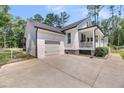 View of the garage and side of the house with well-maintained landscaping at 119 White Picket Ln, Summerville, SC 29483