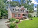 Lovely brick home featuring a well-kept yard, mature landscaping, and a driveway with basketball hoop at 1200 Out Of Bounds Dr, Summerville, SC 29485