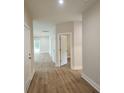 Neutral hallway with laminate flooring and white trim leads to various rooms of the house at 1207 Albert Storm Ave, Moncks Corner, SC 29461