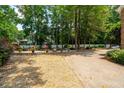 Tranquil backyard featuring manicured landscaping, a pond, and mature trees at 125 Drayton Dr, Summerville, SC 29483