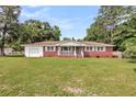 Attractive brick house with a white trim, well-kept lawn, and attached garage at 127 Roberts Rd, Summerville, SC 29483
