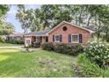 Lovely brick home featuring a circular window and attractive landscaping at 1391 Fairfield Ave, Charleston, SC 29407
