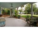 Inviting covered porch featuring stylish seating, potted plants, and a serene outdoor ambiance at 1408 Goblet Ave, Mount Pleasant, SC 29464