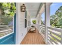 Inviting porch with rocking chairs, lantern and blue painted ceiling, perfect for relaxation at 1494 N Lakeshore Dr, Mount Pleasant, SC 29466