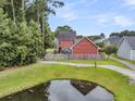 Aerial view of the backyard showing the property line and a small pond at 1576 Nautical Chart Dr, Charleston, SC 29414