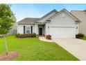 Well-maintained single-Gathering home with green lawn, trimmed bushes, and a driveway leading to the garage at 158 Hayworth Rd, Summerville, SC 29486