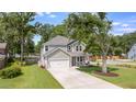 Charming two-story home with a well-manicured lawn and long private driveway at 1607 Waterside Blvd, Moncks Corner, SC 29461