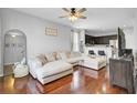 Open living room with hardwood floors, a plush sectional sofa, and dark-stained cabinets at 1634 Eider Down Dr, Summerville, SC 29483
