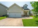 Charming home showcasing an attached garage, a welcoming front door, and well-maintained landscaping at 1689 Eider Down Dr, Summerville, SC 29483