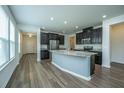 Modern kitchen features dark cabinets, stainless steel appliances, and a granite island at 1689 Eider Down Dr, Summerville, SC 29483