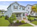 Inviting two-story home with well-maintained landscaping, a cozy front porch, and a charming neighborhood setting at 1832 Agate Bay Dr, Mount Pleasant, SC 29466