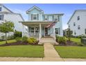 Inviting two-story home with a cozy front porch, manicured lawn, and charming curb appeal at 1832 Agate Bay Dr, Mount Pleasant, SC 29466