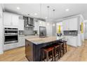 Bright kitchen featuring white cabinetry, stainless steel appliances, and a large center island at 1928 Mossdale Dr, Johns Island, SC 29455