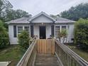 White exterior single story home featuring a wheelchair ramp at 207 Cedar St, Saint George, SC 29477