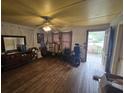 Large living room featuring hardwood floors and a ceiling fan at 207 Cedar St, Saint George, SC 29477