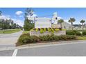 Community entrance sign with colorful flower beds, welcoming residents and guests to Woodwinds at 228 Lucca Dr, Summerville, SC 29486