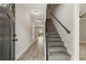 Bright hallway featuring wood floors, stairs leading to the second level, and a view of the backyard at 2960 Blackfish Rd, Johns Island, SC 29455