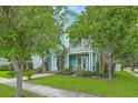 Charming two-story home with a porch and well-maintained lawn surrounded by mature trees at 300 Foxglove Ave, Summerville, SC 29483